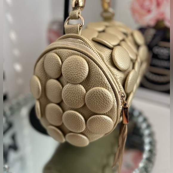 unique design with embossed circular details and a structured, metallic handle. - Picture 4 of 12